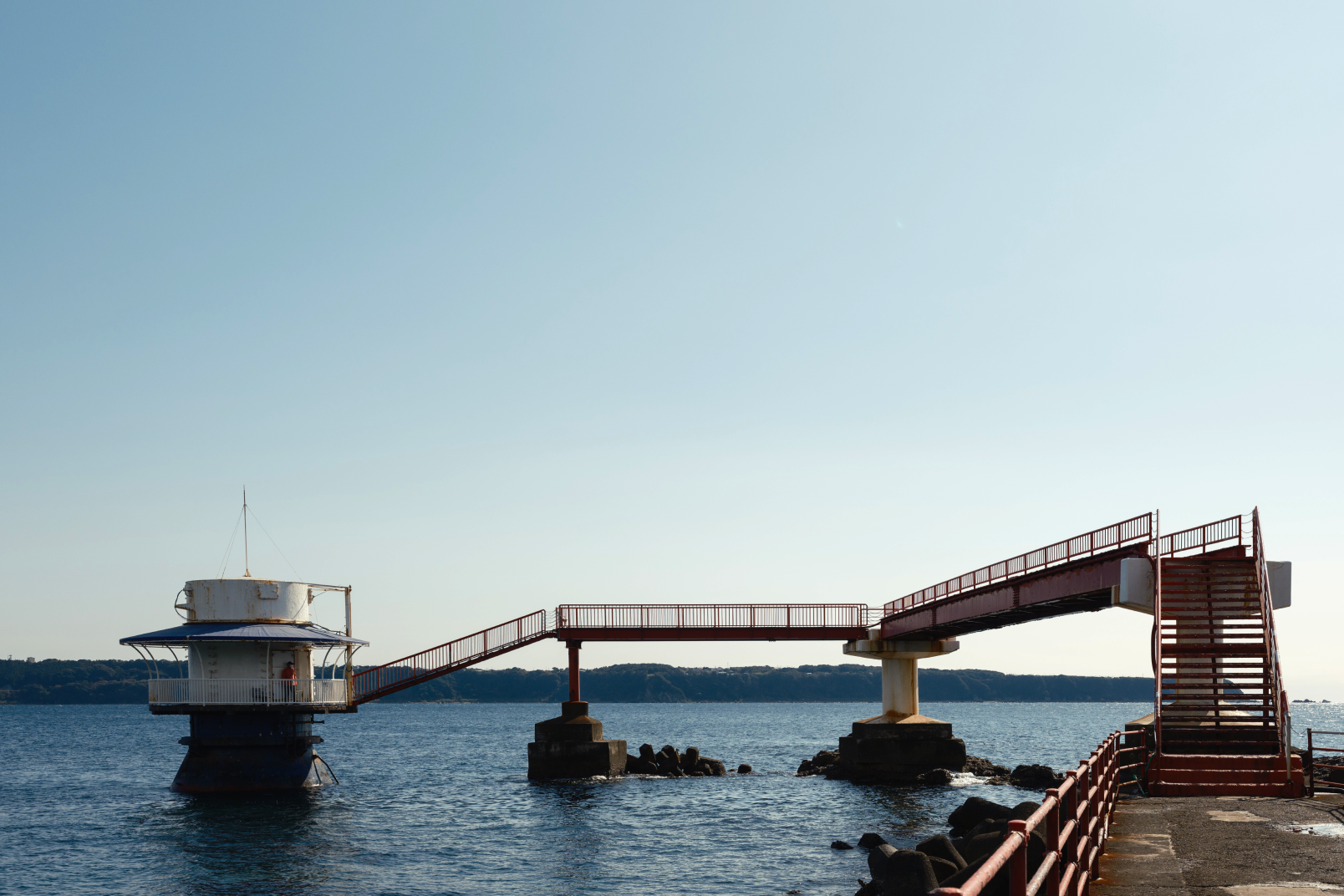 a bridge over water with a building and a bridge