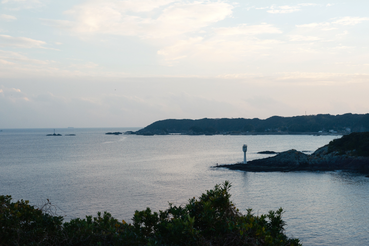 a lighthouse on an island in the middle of a body of water
