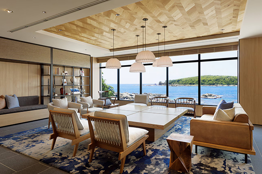 a room with a large table and chairs and a large window