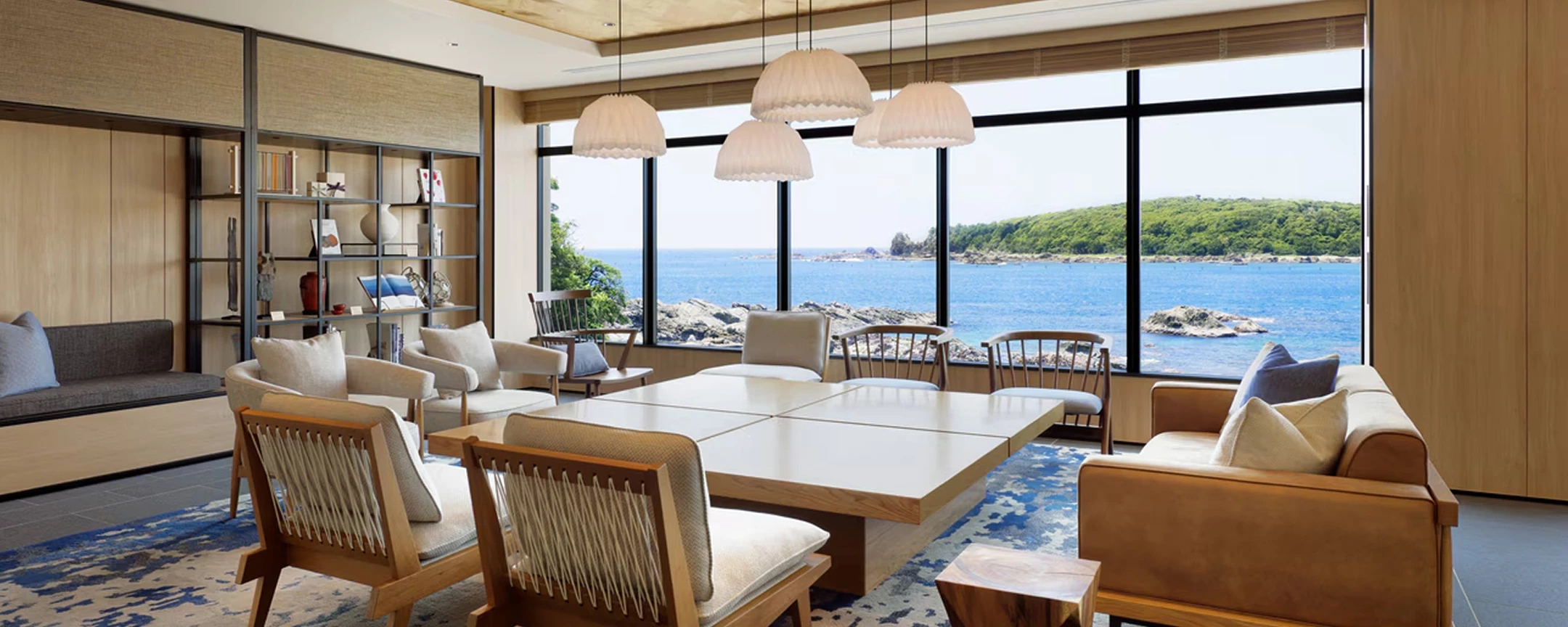 a room with a large table and chairs and a large window
