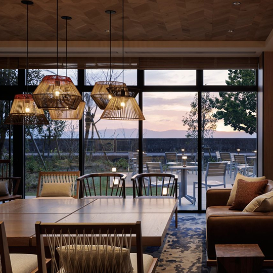 a room with a table and chairs and a large window