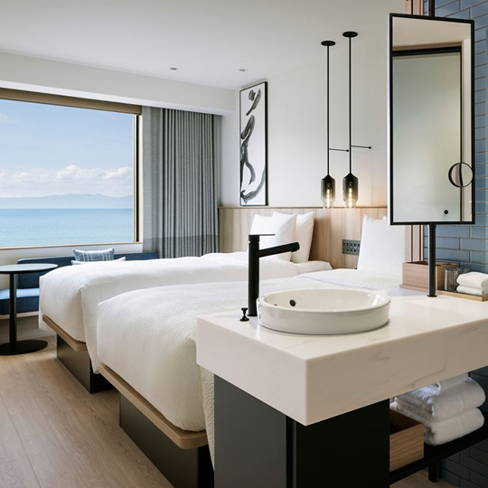 a room with two beds and a mirror