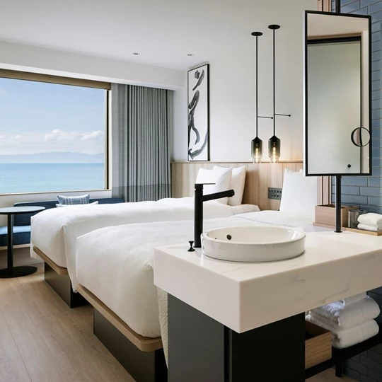 a room with two beds and a mirror