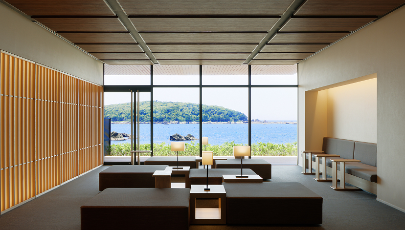 a room with large windows and a view of water and land