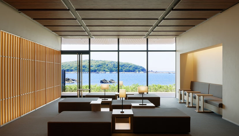 a room with large windows and a view of water and land