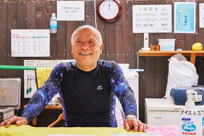 a man sitting at a table smiling