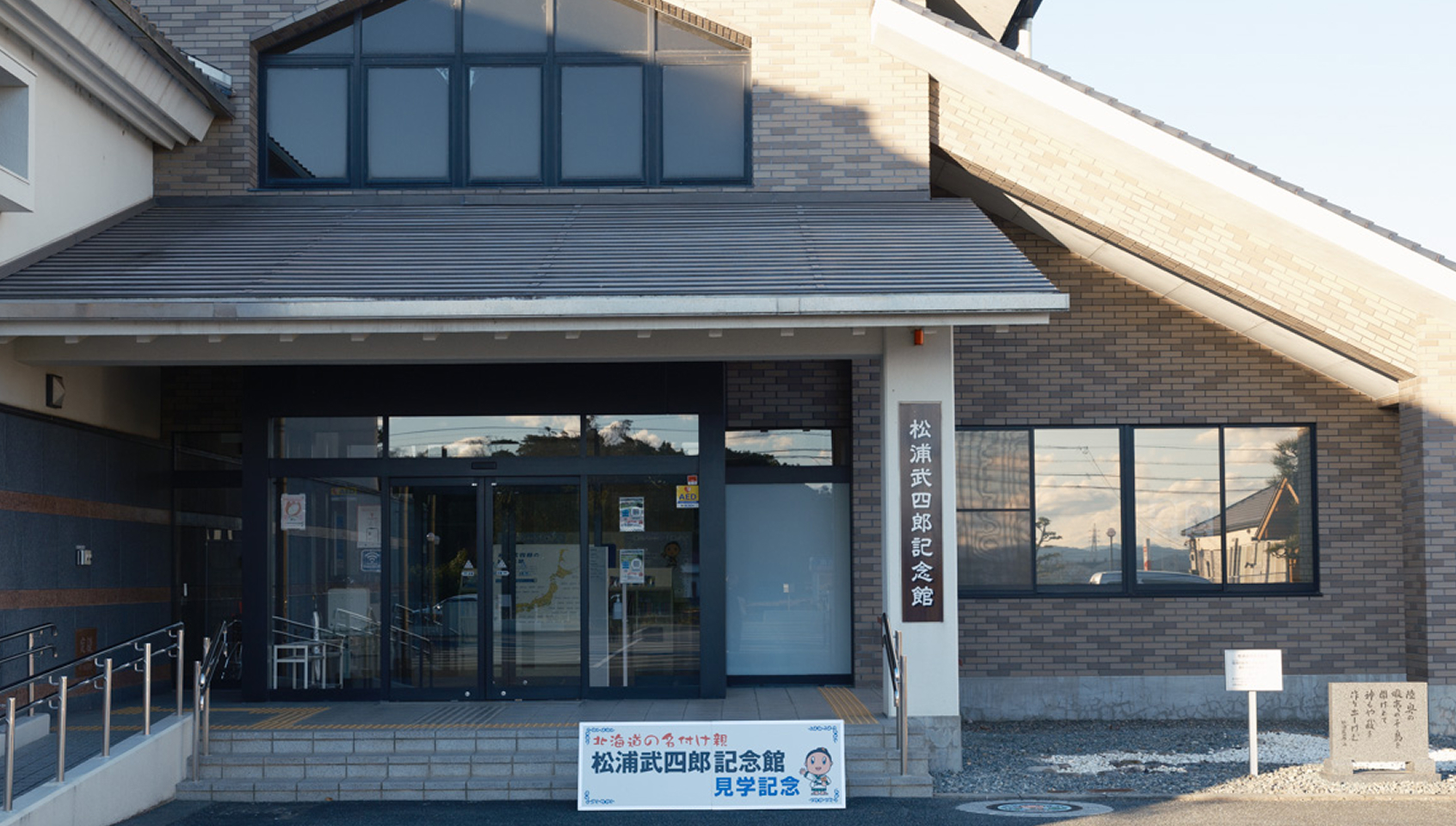 a building with glass doors and a sign