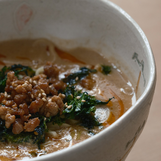 a bowl of soup with meat and vegetables
