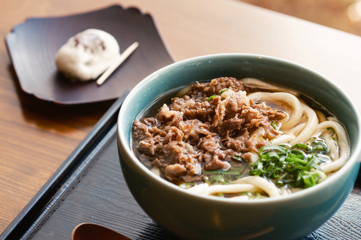 a bowl of soup with meat and noodles