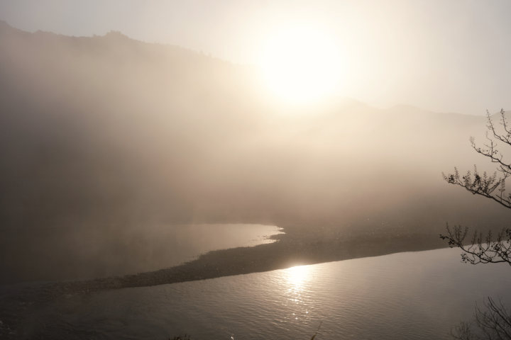 a foggy morning over a lake