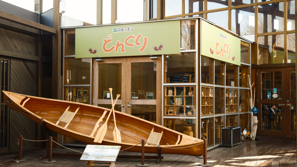 a wooden boat outside a store