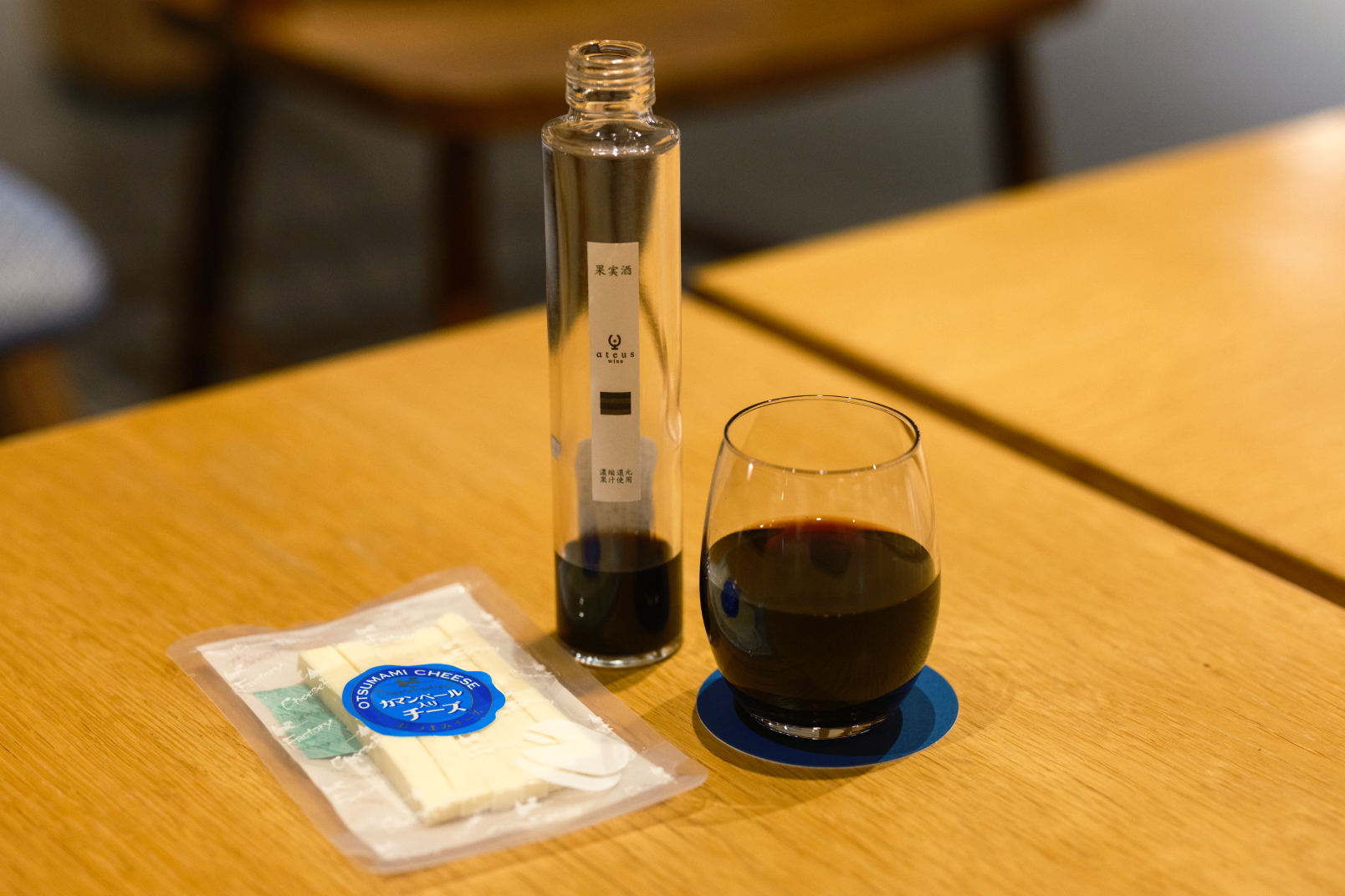 a bottle of liquid and a glass of liquid on a table