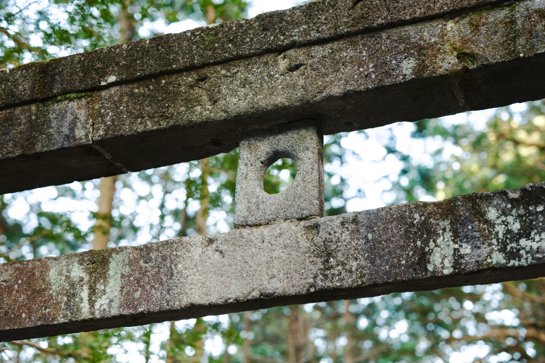 a stone fence with a hole in it