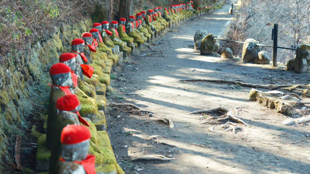 a path with rocks and red hats
