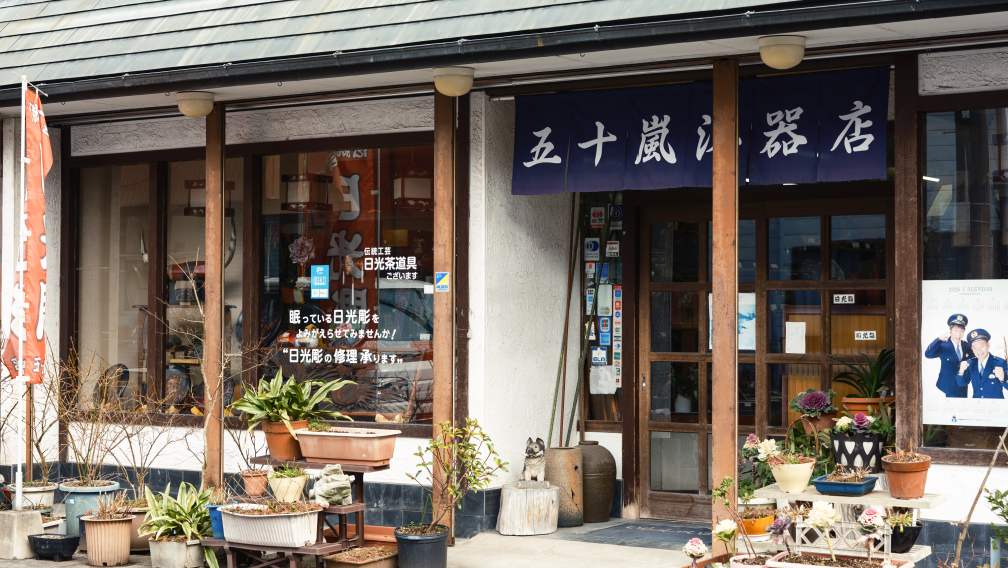 a store front with a dog sitting on a stump