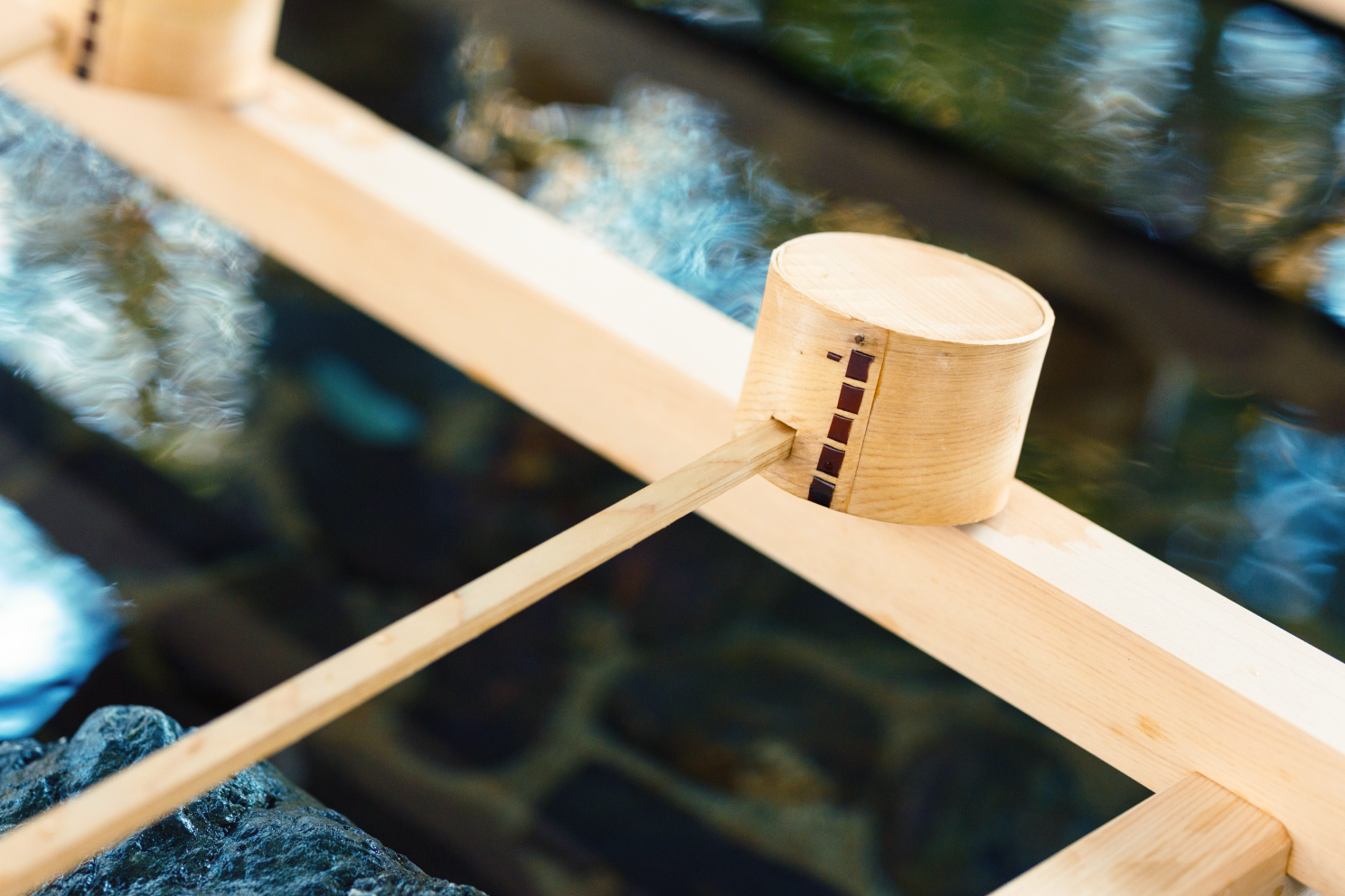 a wooden object with a stick on top of it