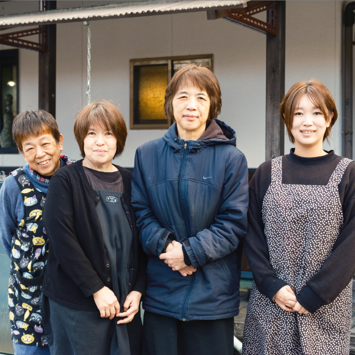 a group of women standing together smiling