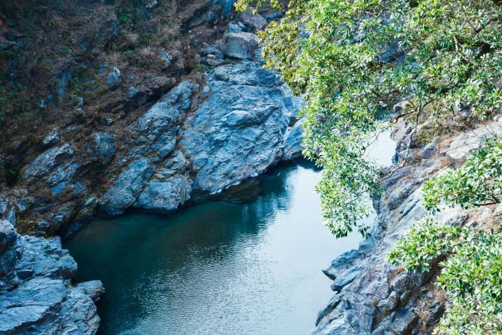 a river between rocks with trees