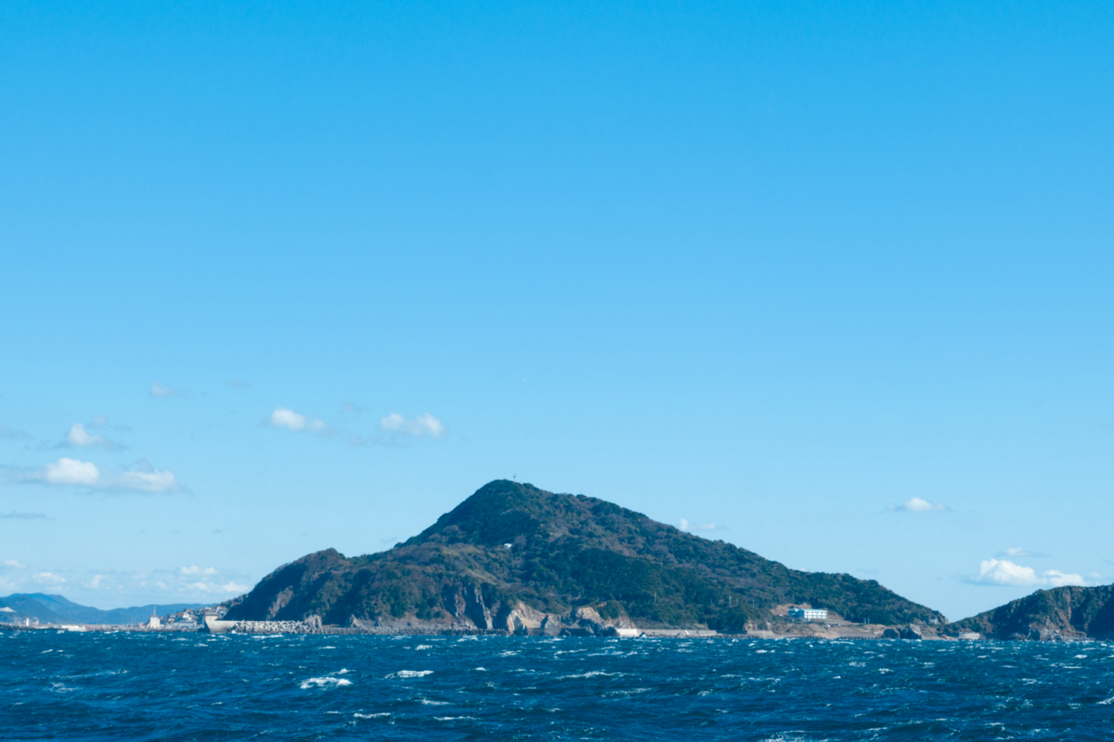 a large island with a hill in the background