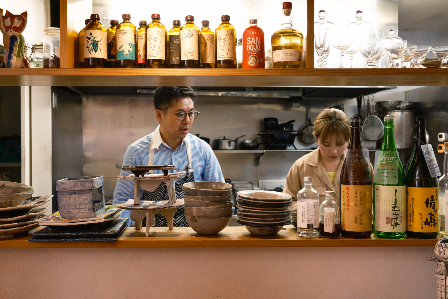 a man and woman in a kitchen