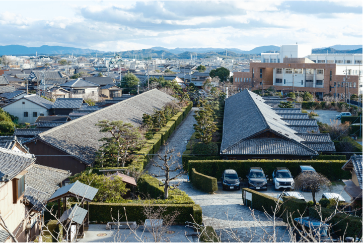 a group of buildings with bushes and trees