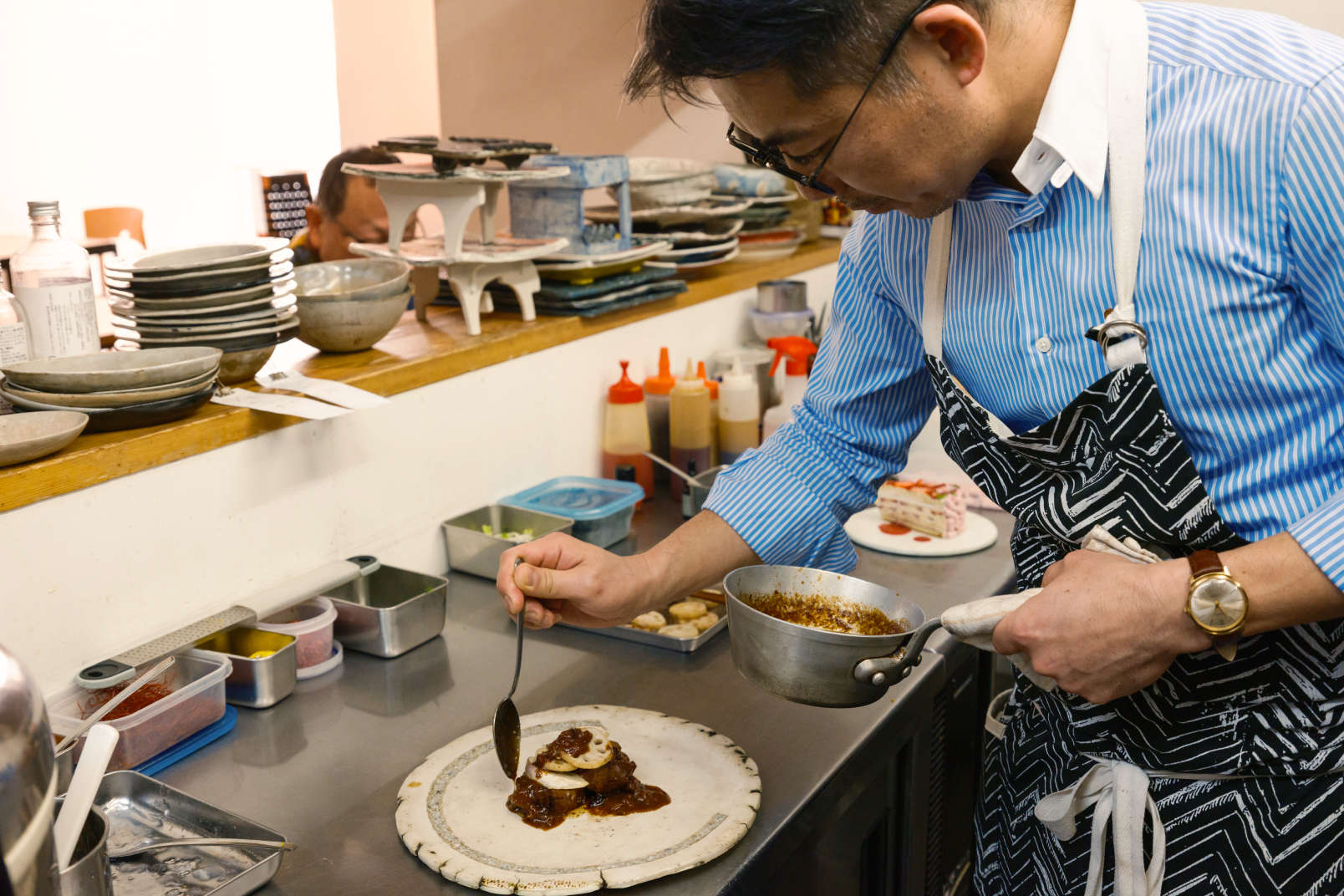 a man in a kitchen preparing food