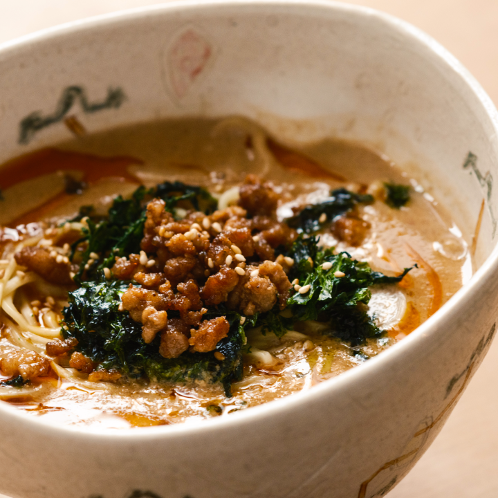 a bowl of soup with meat and noodles