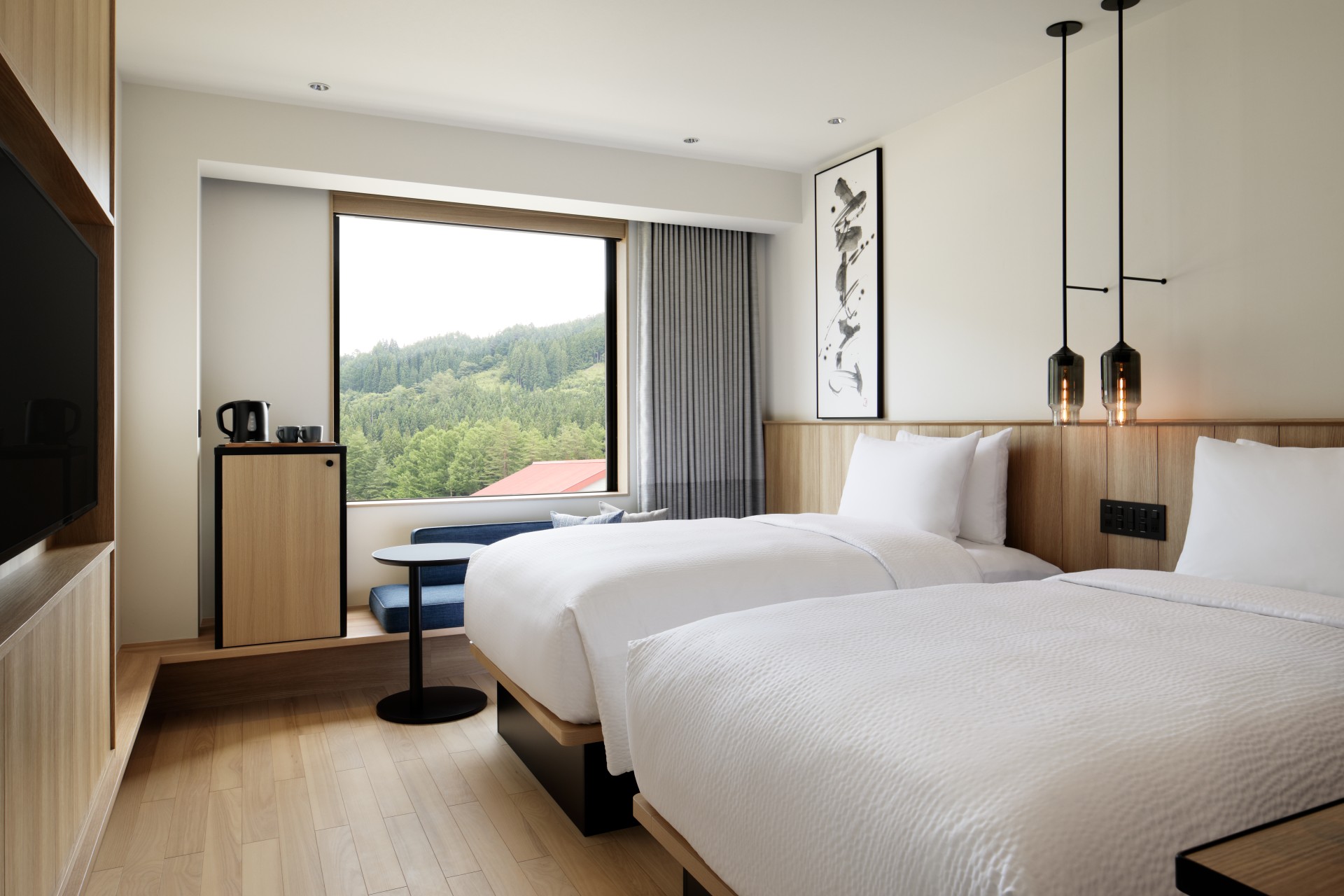 a room with two beds and a window