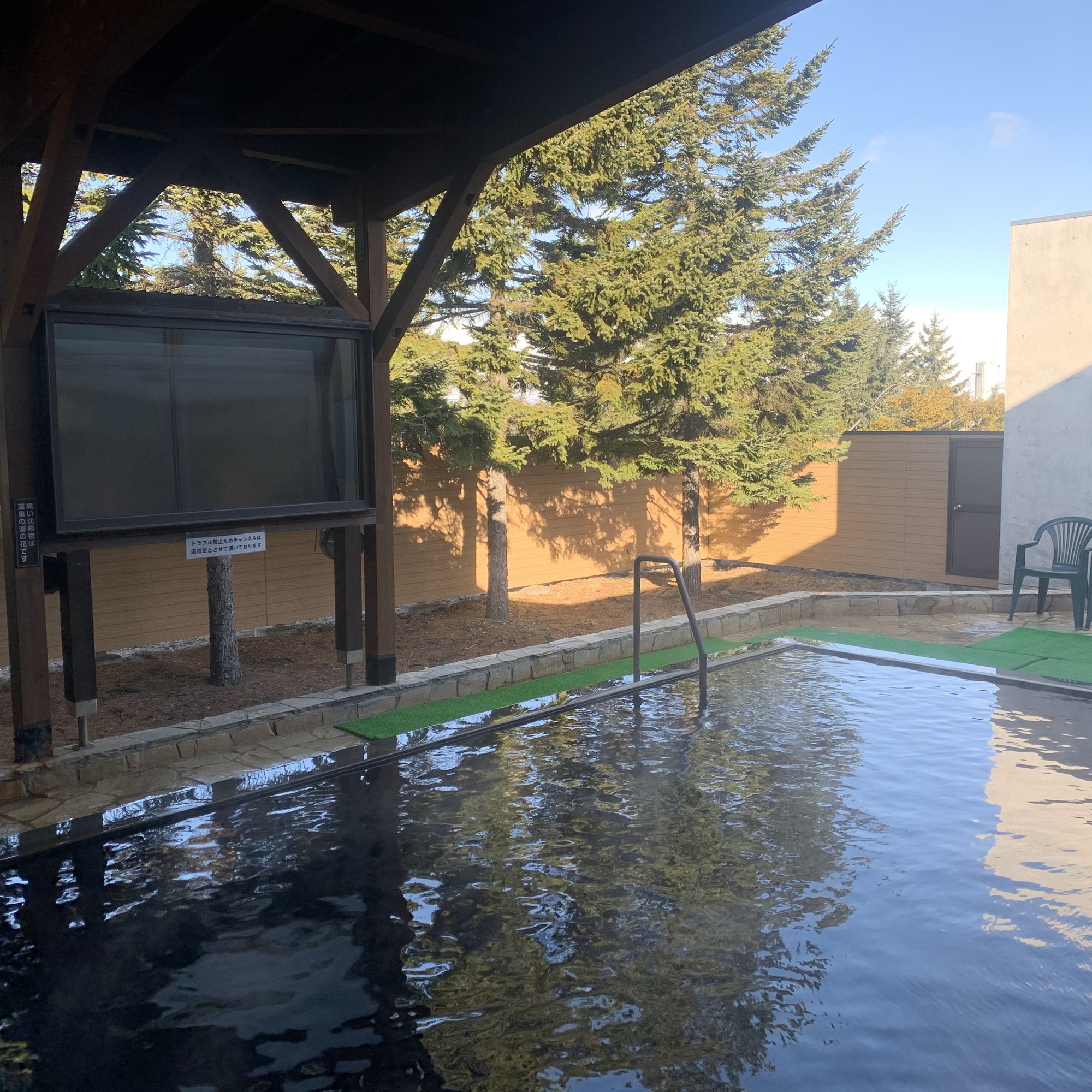 a pool with a chair and a television