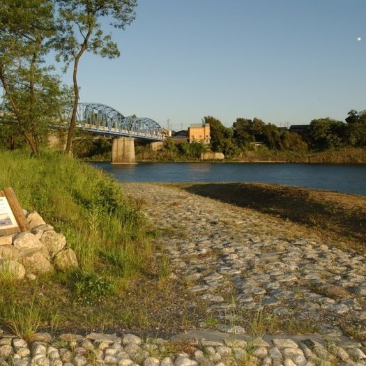 a stone path next to a river
