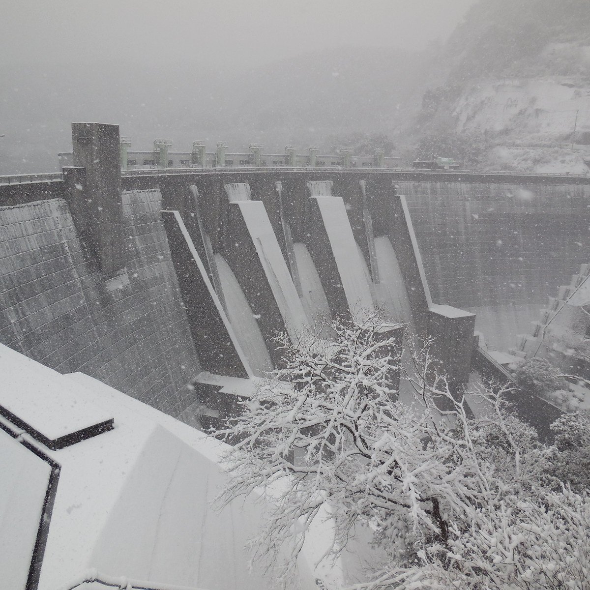 a dam with snow falling