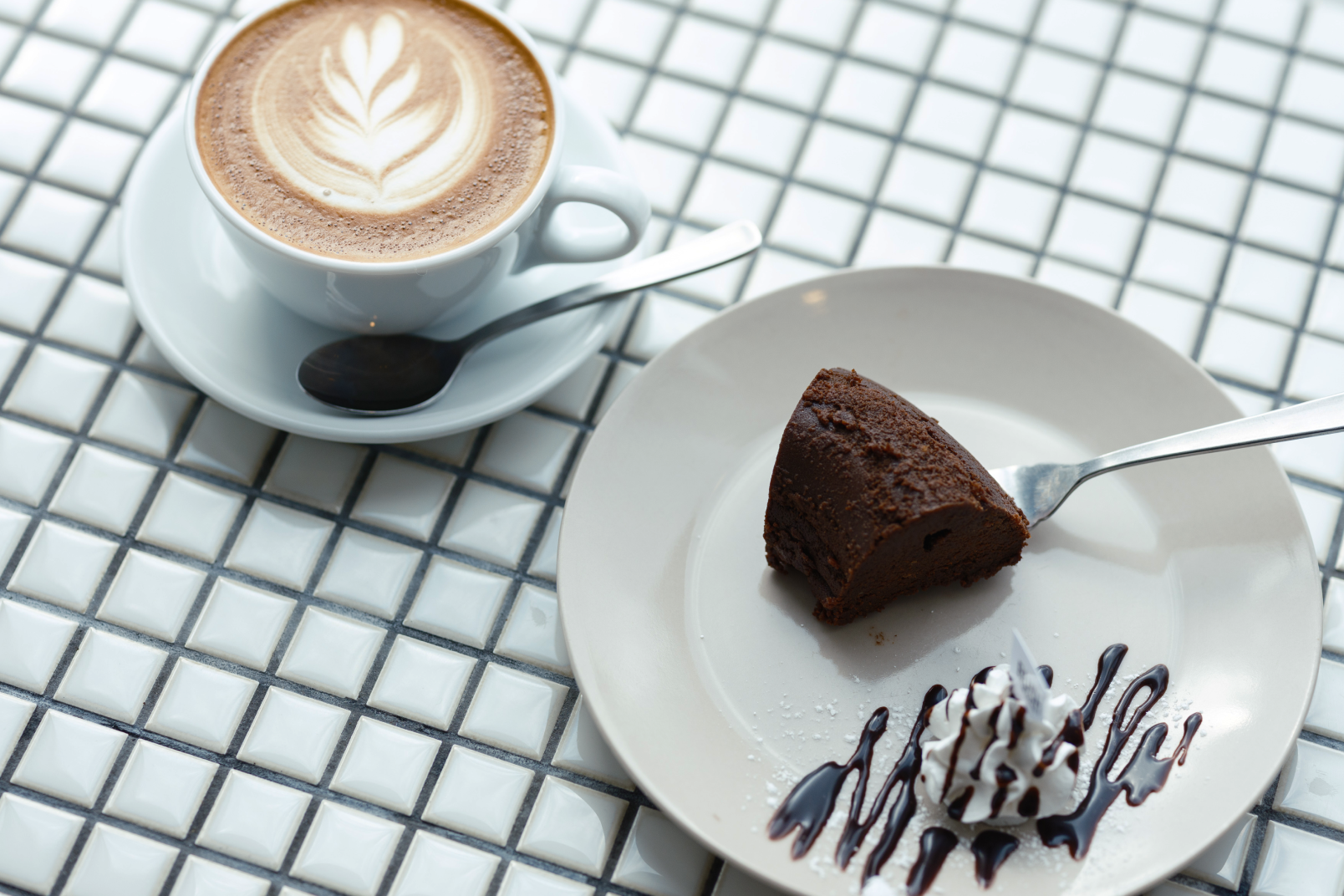a plate of chocolate cake and a cup of coffee
