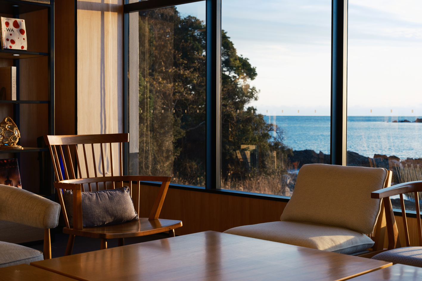 a room with a table and chairs by a window