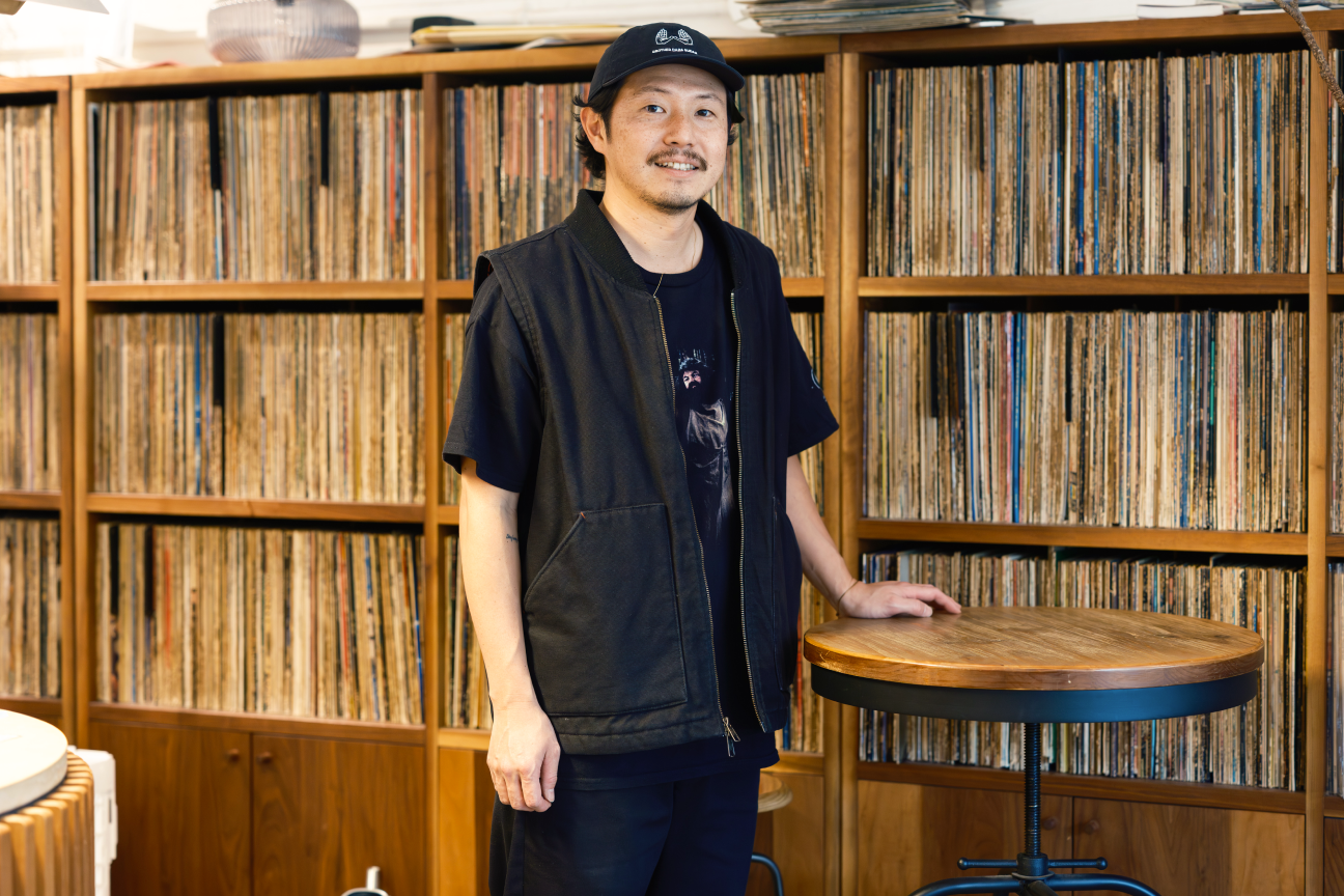 a man standing in front of a record shelf