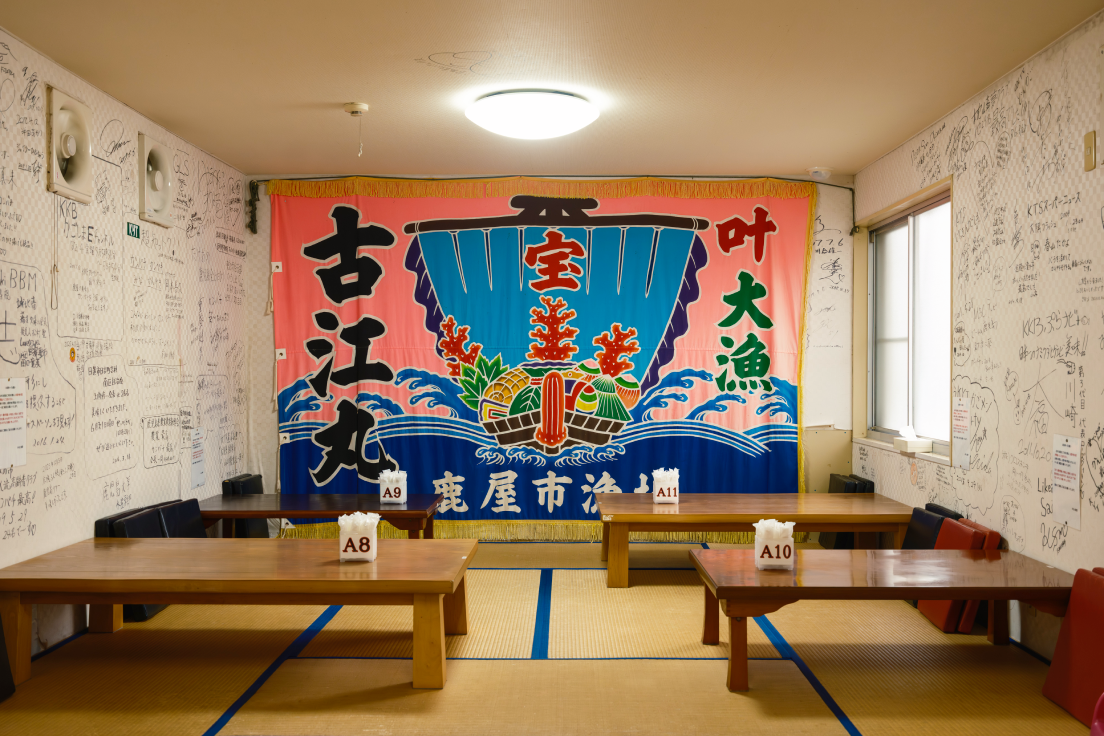a room with tables and a banner