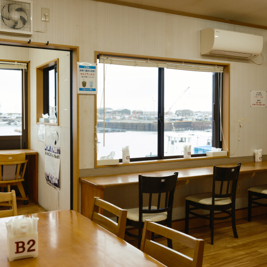 a room with a window and chairs