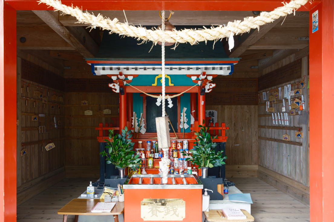a small shrine with a rope from it