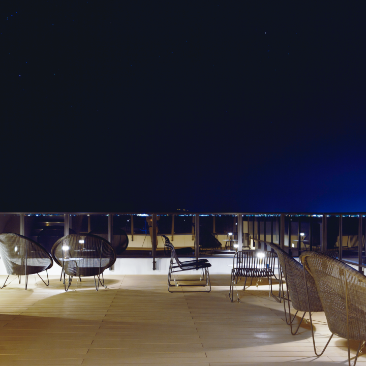 chairs on a deck with a railing and chairs