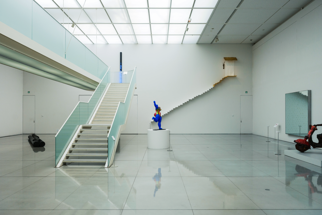 a person in blue suit in a room with stairs