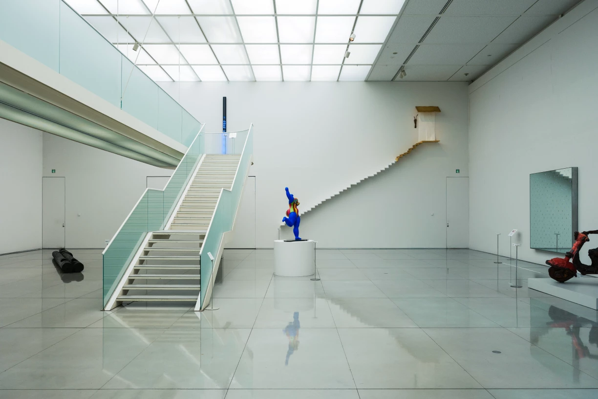 a person in blue suit in a room with stairs