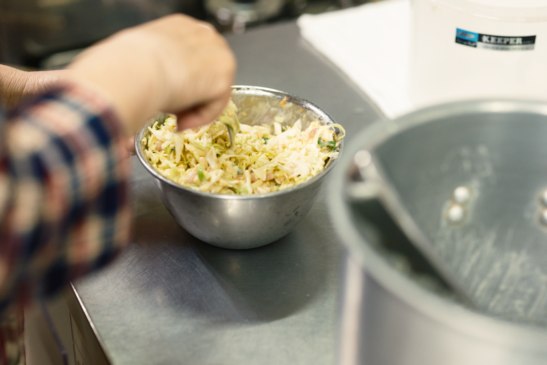 a person mixing food in a bowl