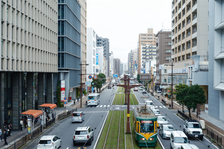 a street with cars and buses in a city