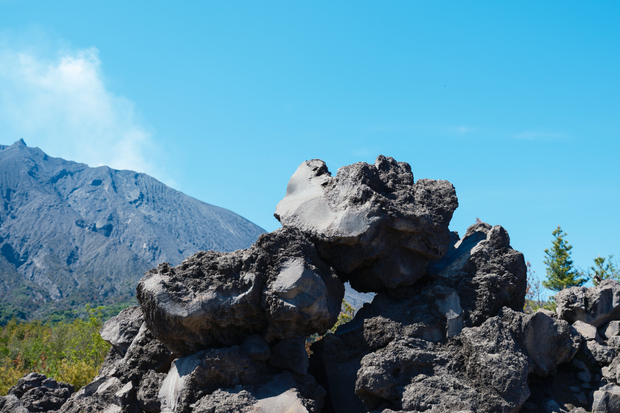 a pile of rocks with a mountain in the background