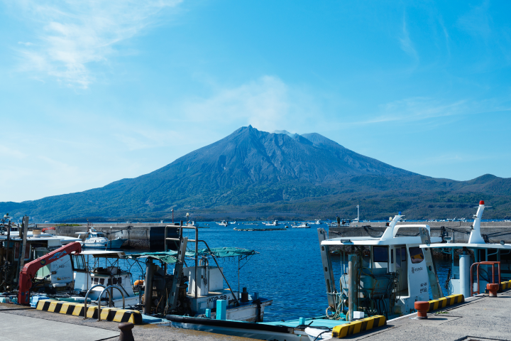 boats parked boats in a harbor with a mountain in the background