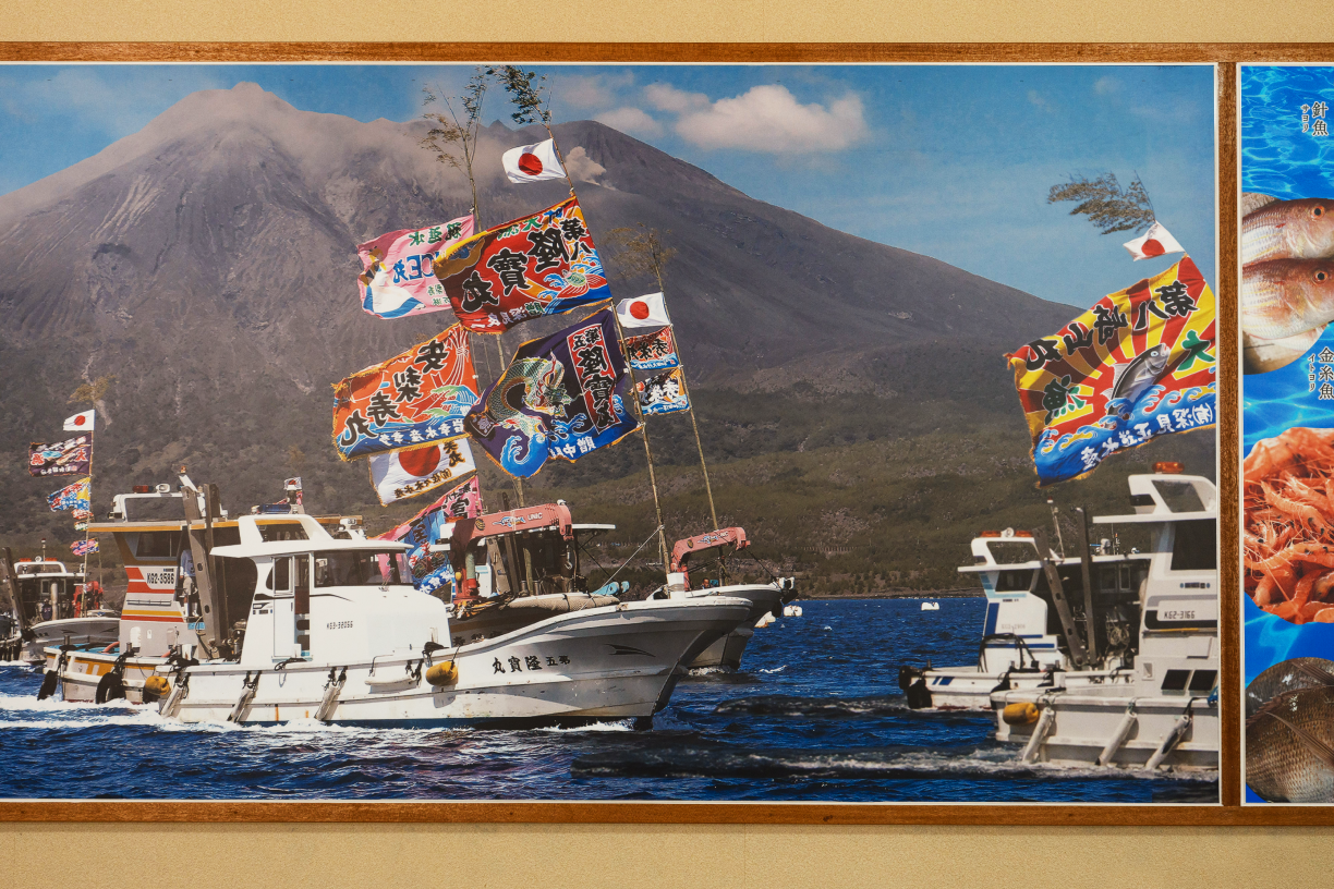 a group of boats with flags on the water