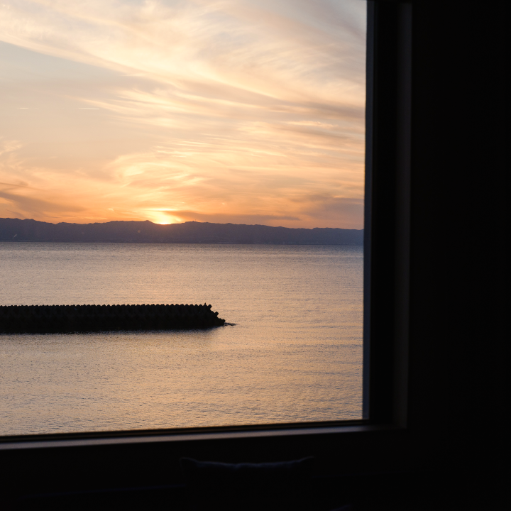 a view of a sunset from a window of a room