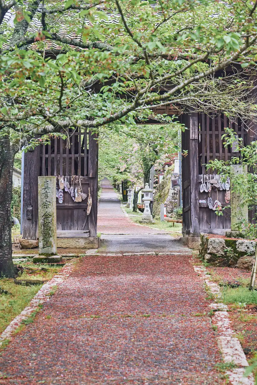 a wooden gate with a path leading to it