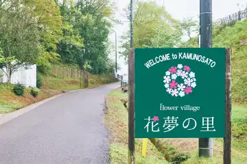 a sign on a pole next to a road