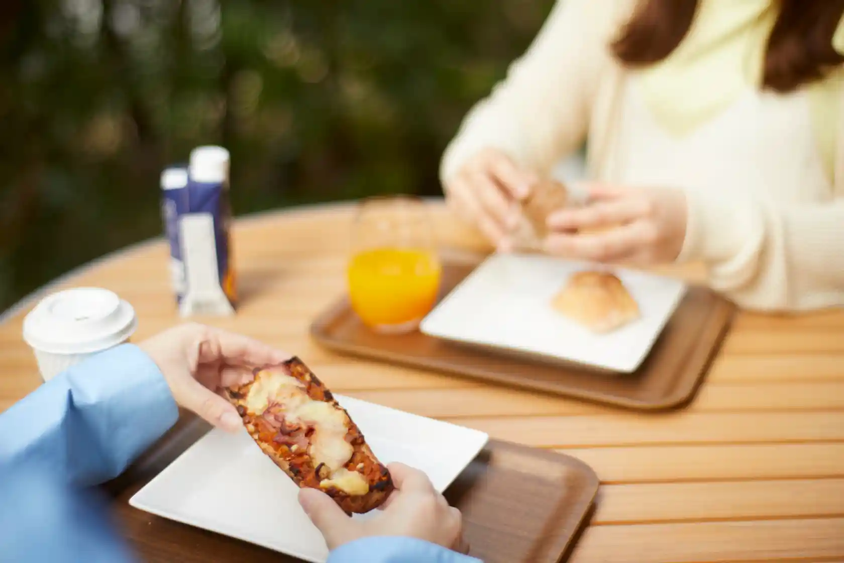 a person holding a piece of bread
