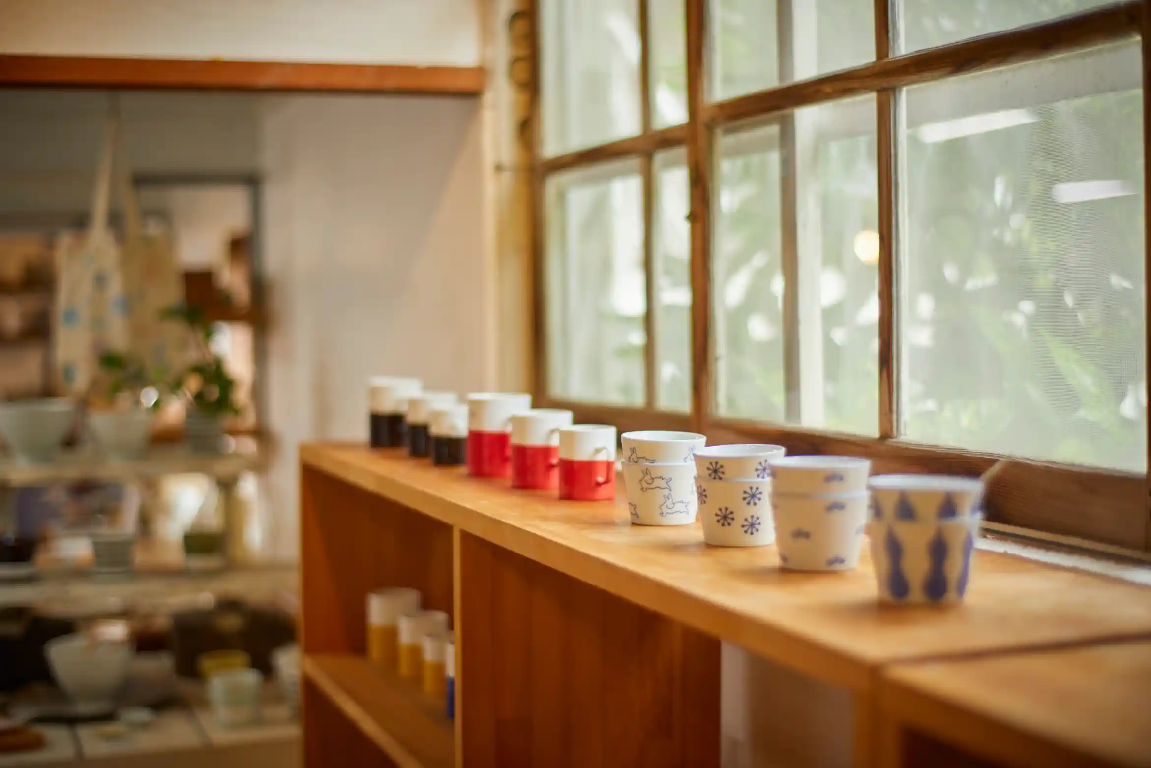 a row of cups on a shelf